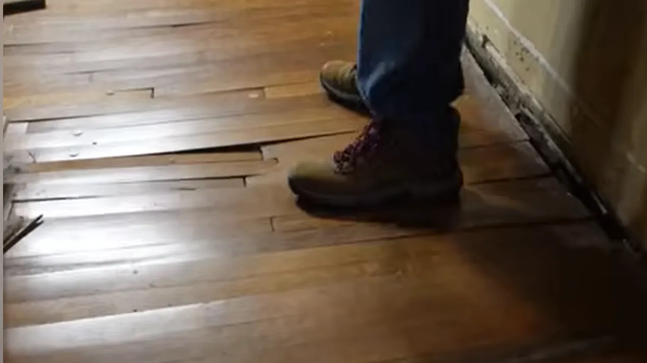 Buckled hardwood floor from water damage in Lincoln, NE